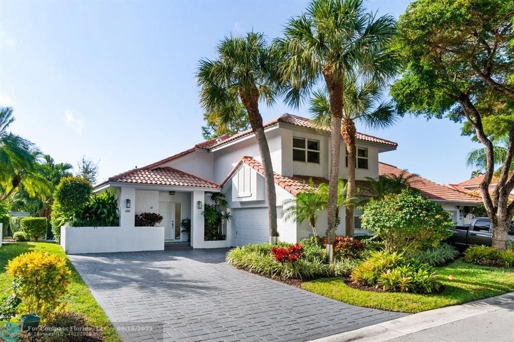 2058 Northwest 52nd Street Boca Raton, FL 33496 - Photo 2 of 35 a front view of a house with garden
