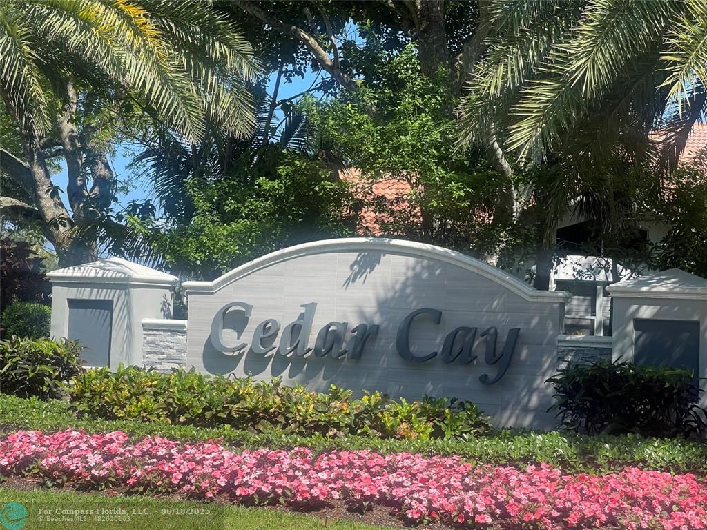 2058 Northwest 52nd Street Boca Raton, FL 33496 - Photo 28 of 35 a view of sign board with flower garden