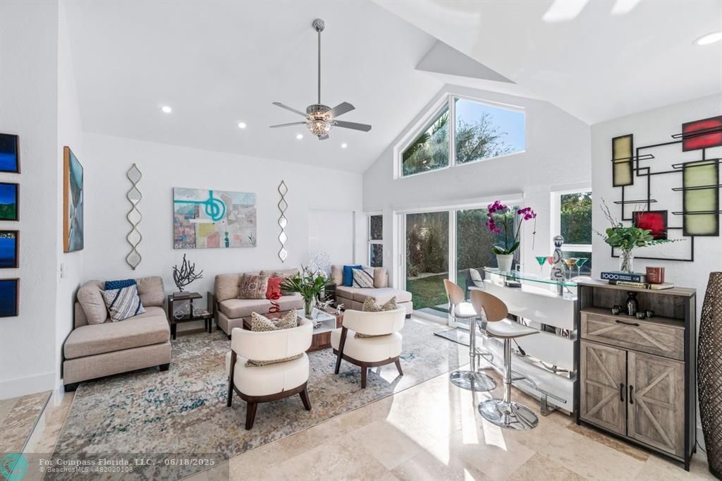 2058 Northwest 52nd Street Boca Raton, FL 33496 - Photo 5 of 35 a living room with furniture and a fireplace