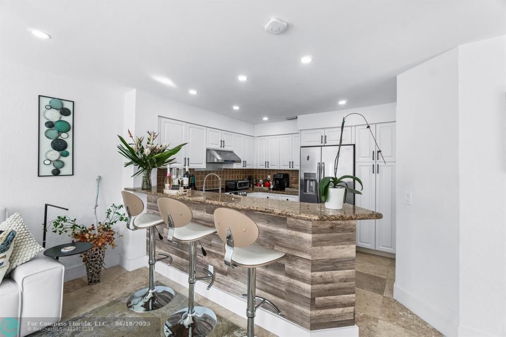 2058 Northwest 52nd Street Boca Raton, FL 33496 - Photo 7 of 35 a living room with furniture and a potted plant