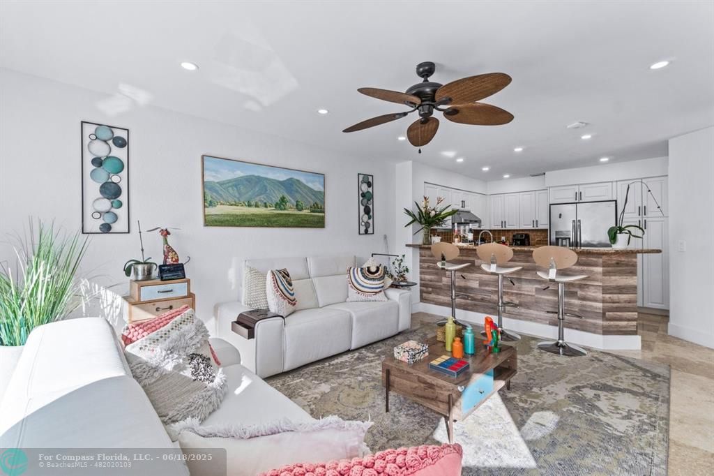2058 Northwest 52nd Street Boca Raton, FL 33496 - Photo 9 of 35 a living room with furniture and kitchen view