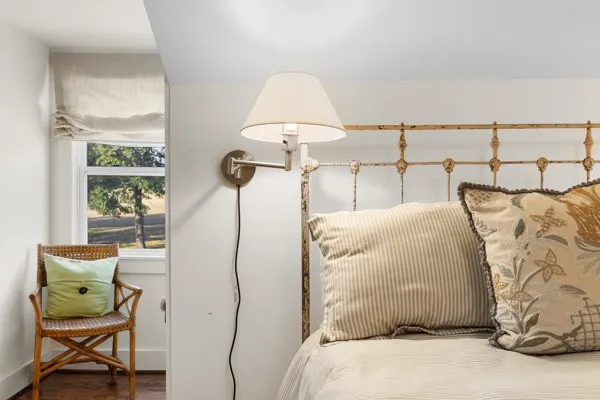 a bedroom with a bed and a chair