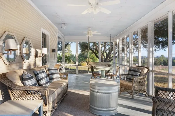 a living room with fireplace furniture and a large window