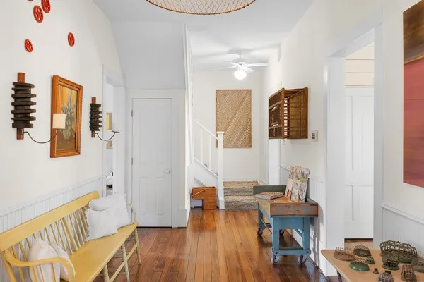 a living room with furniture and a wooden floor