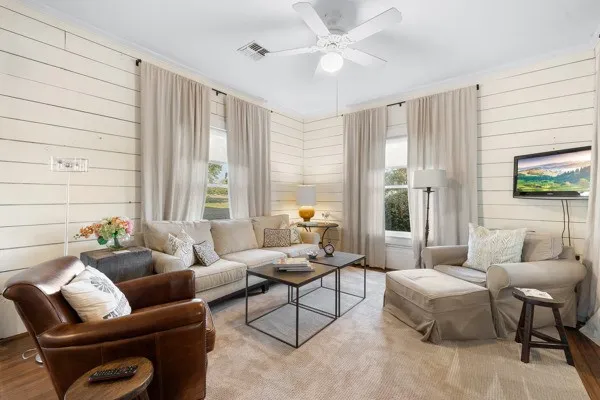 a living room with furniture and a large window