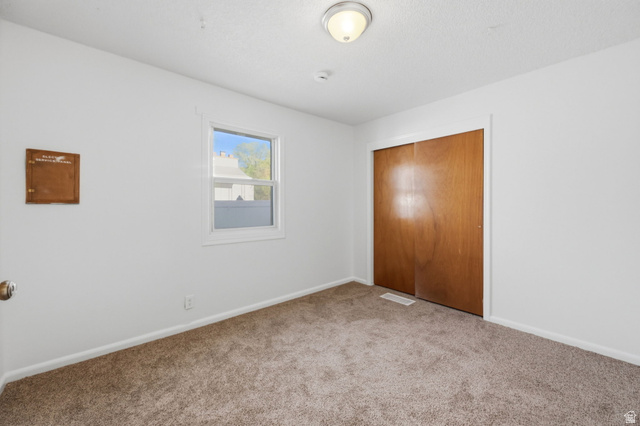 708 9th Street Ogden, UT 84404 - Photo 8 of 17 Unfurnished bedroom featuring a closet and carpet floors
