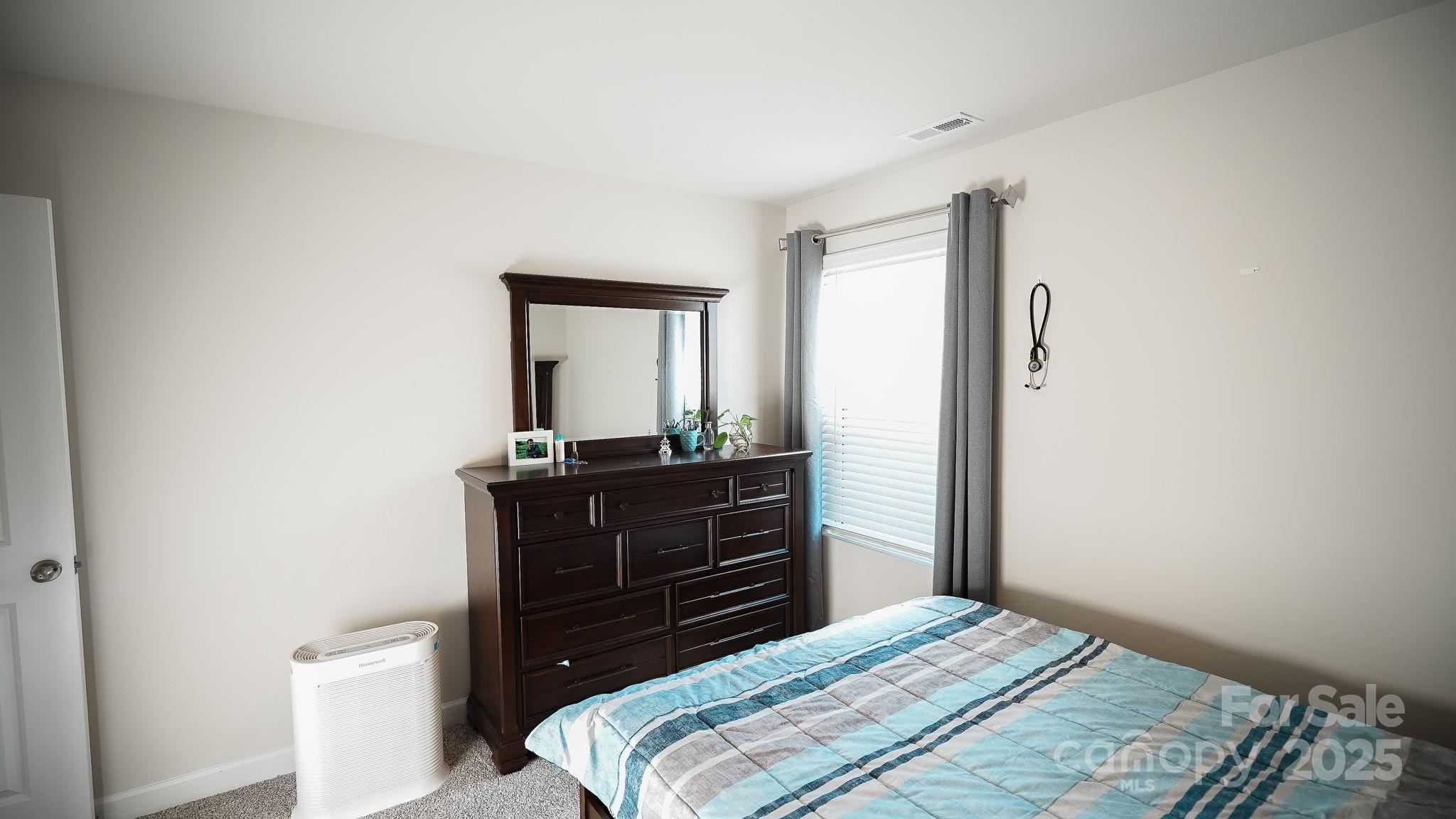 486 Olympia Way York, SC 29745 - Photo 23 of 34 a bedroom with a bed and a dresser