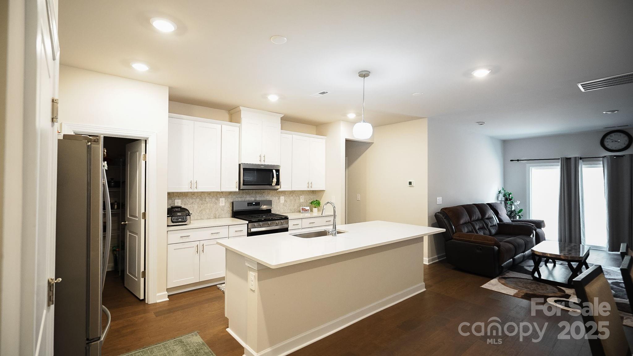 486 Olympia Way York, SC 29745 - Photo 4 of 34 a kitchen with a sink dishwasher a refrigerator and a stove with wooden floor
