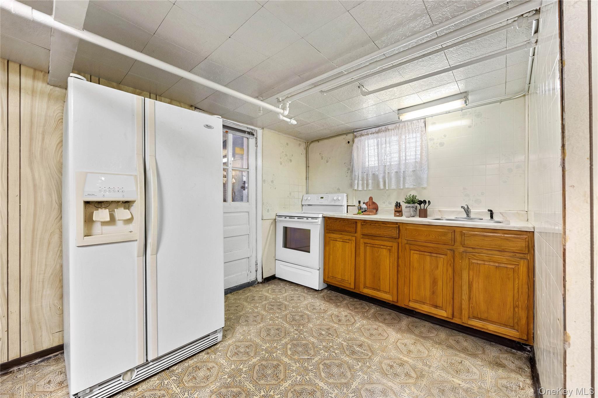 37-07 20th Road Queens, NY 11105 - Photo 15 of 24 a kitchen with stainless steel appliances a refrigerator sink and cabinets