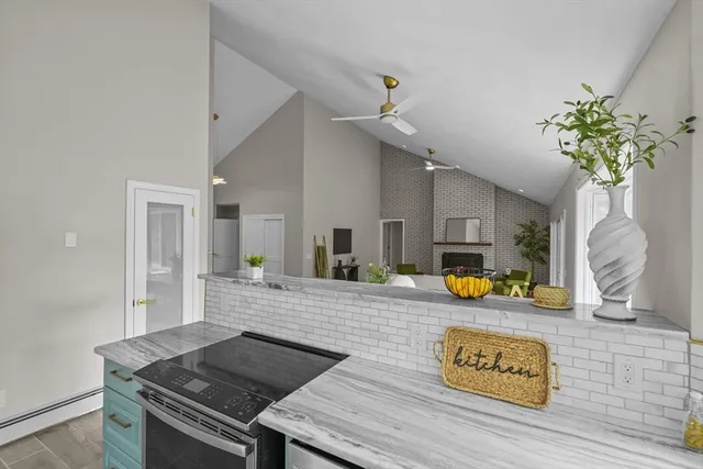 a kitchen with a stove and a chandelier