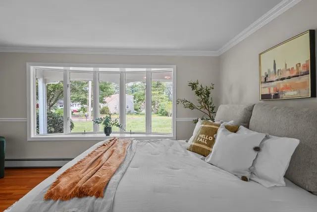 a bed room with a bed and a large window