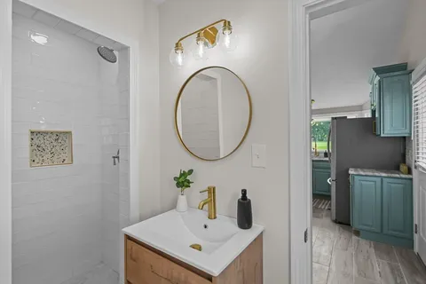 a bathroom with a sink mirror and vanity