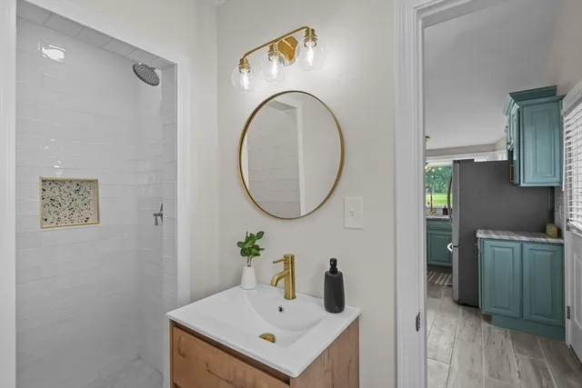a bathroom with a sink mirror and vanity