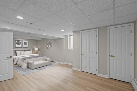 a bedroom with a bed and a painting