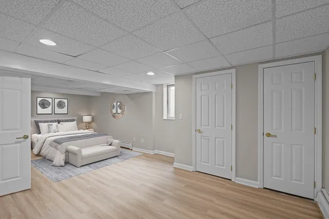 a bedroom with a bed and a painting