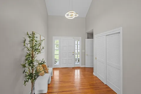 a view of an entryway with wooden floor