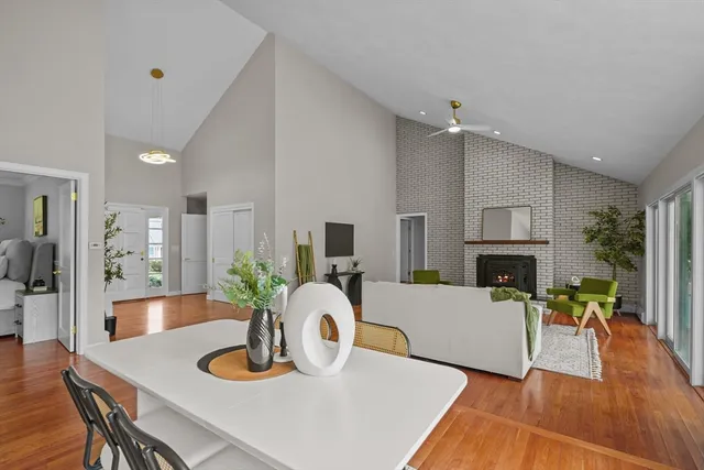 a living room with fireplace furniture and a wooden floor