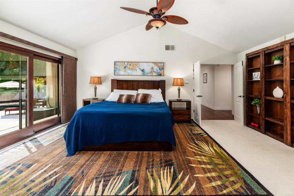 6541 Vispera Place Carlsbad, CA 92009 - Photo 26 of 54 a bedroom with a bed dresser and a large window