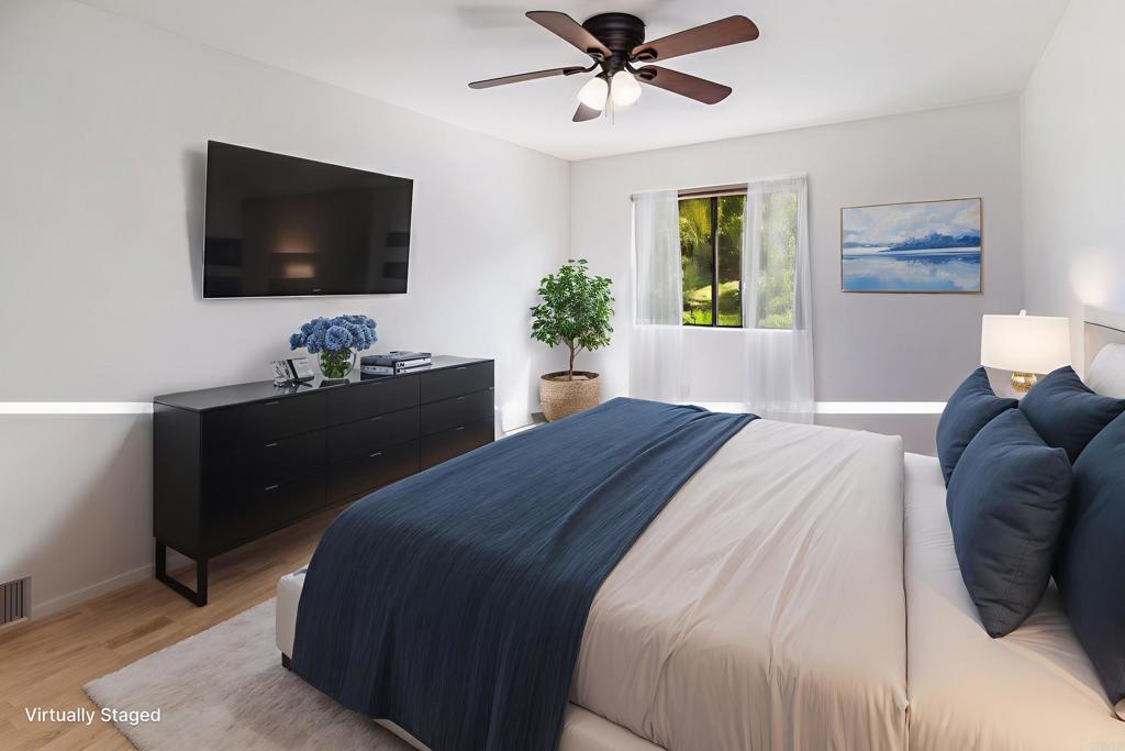 6541 Vispera Place Carlsbad, CA 92009 - Photo 32 of 54 a bedroom with a bed and a flat screen tv