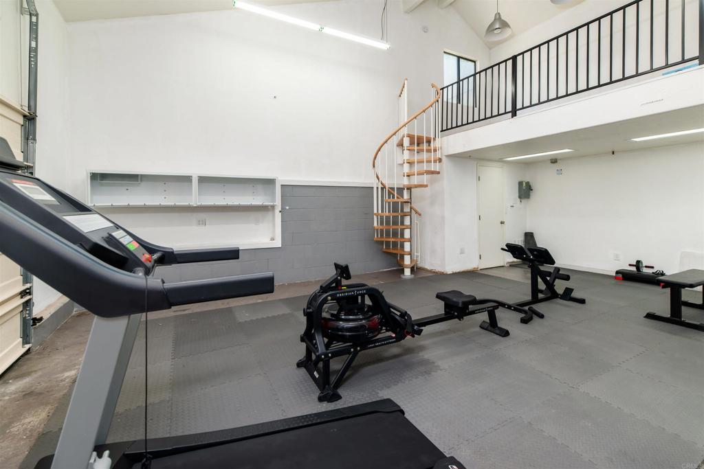 6541 Vispera Place Carlsbad, CA 92009 - Photo 45 of 54 a room with gym equipment and a chandelier