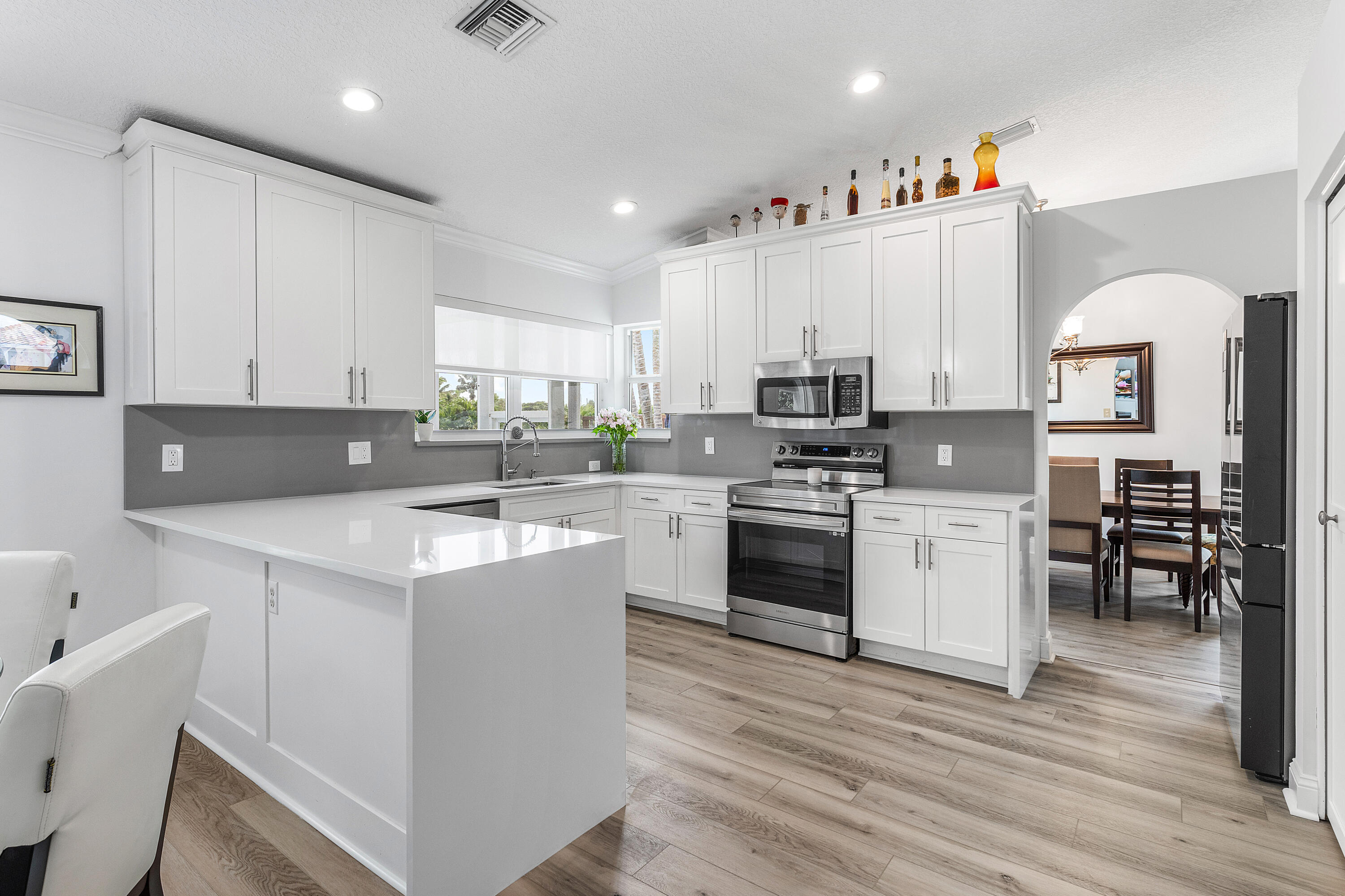 10824 Tea Olive Lane Boca Raton, FL 33498 - Photo 14 of 76 a kitchen with appliances a sink and cabinets