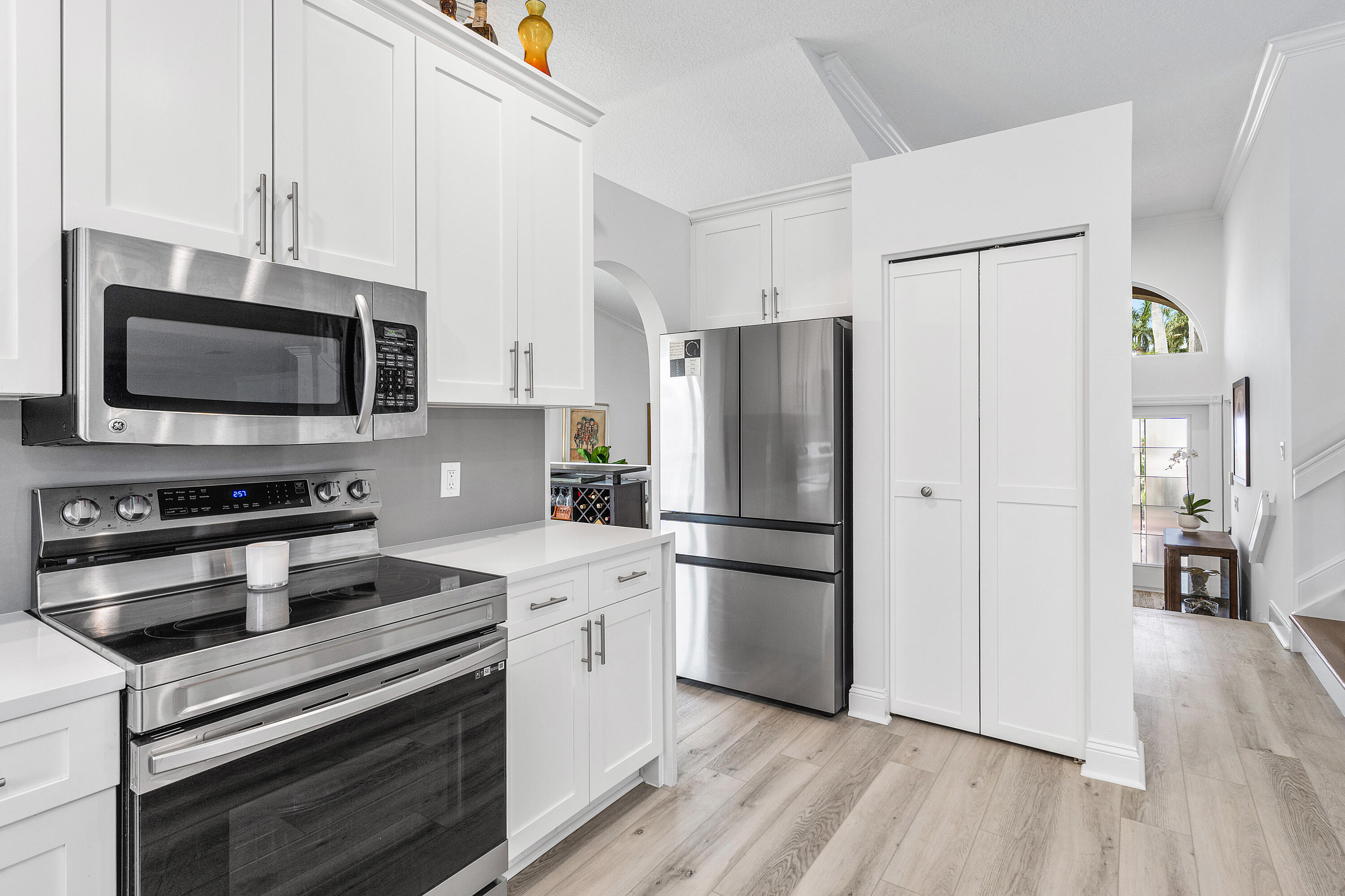 10824 Tea Olive Lane Boca Raton, FL 33498 - Photo 17 of 76 a kitchen with a refrigerator stove and wooden floor