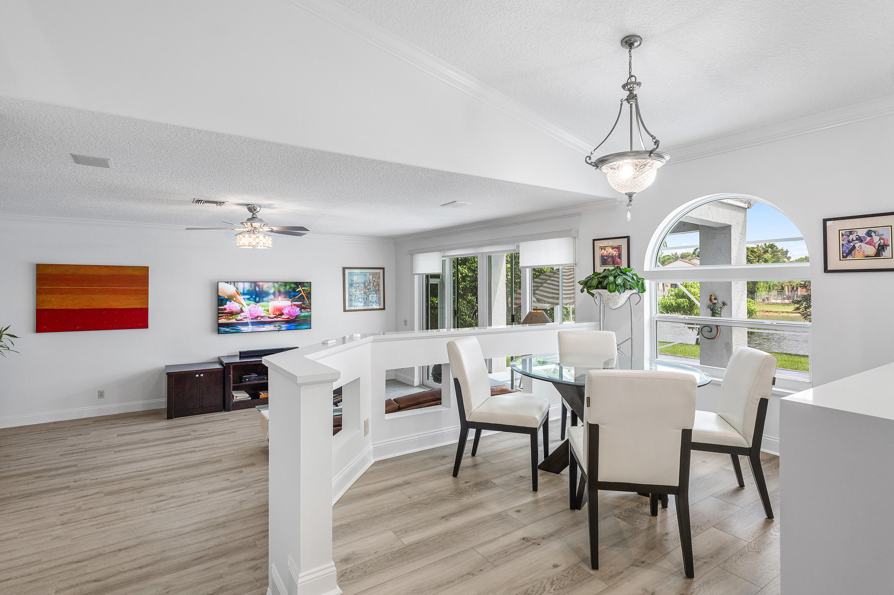 10824 Tea Olive Lane Boca Raton, FL 33498 - Photo 18 of 76 a view of a dining room with furniture a chandelier and wooden floor