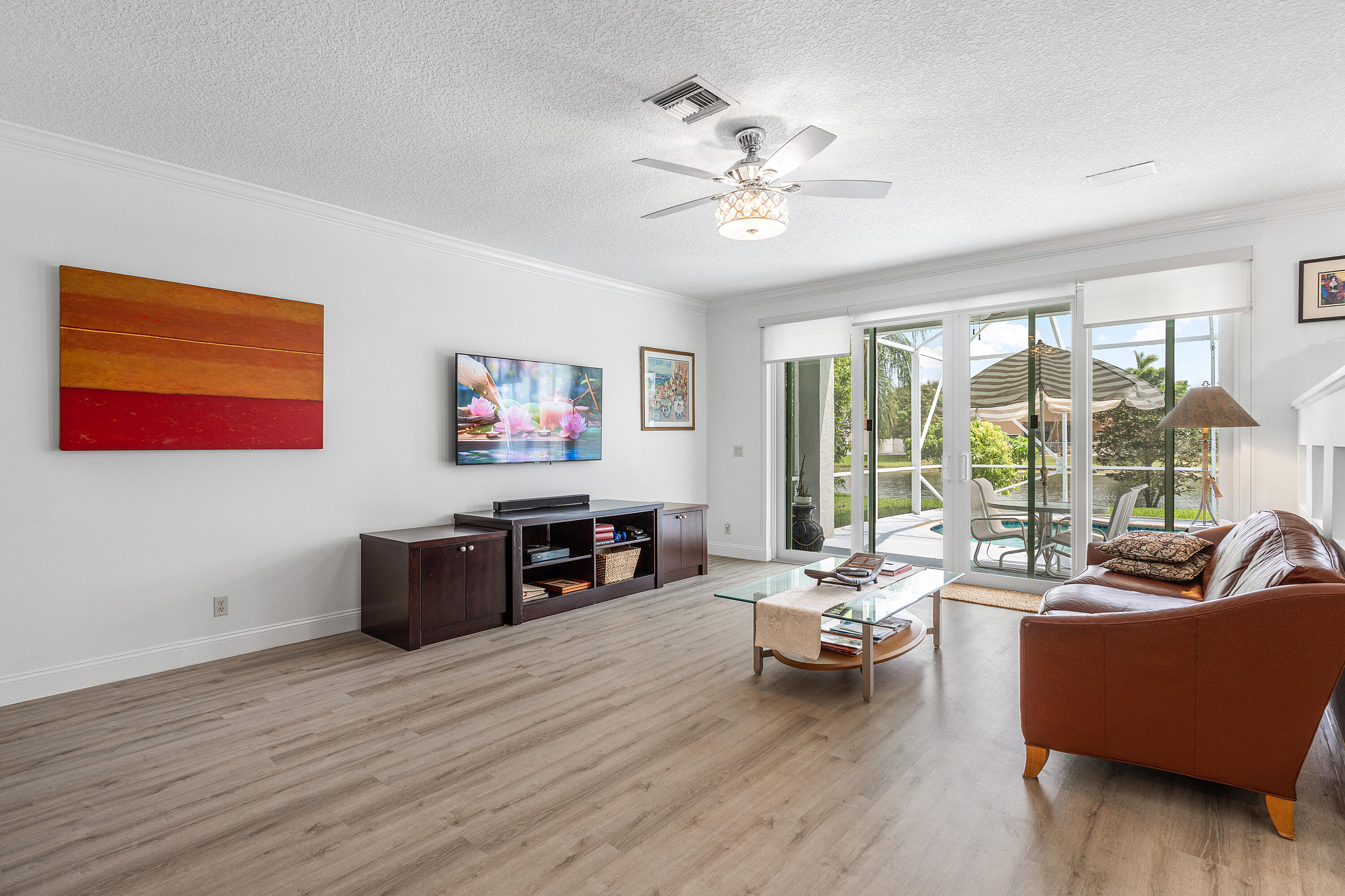 10824 Tea Olive Lane Boca Raton, FL 33498 - Photo 20 of 76 a living room with furniture and a flat screen tv with wooden floor