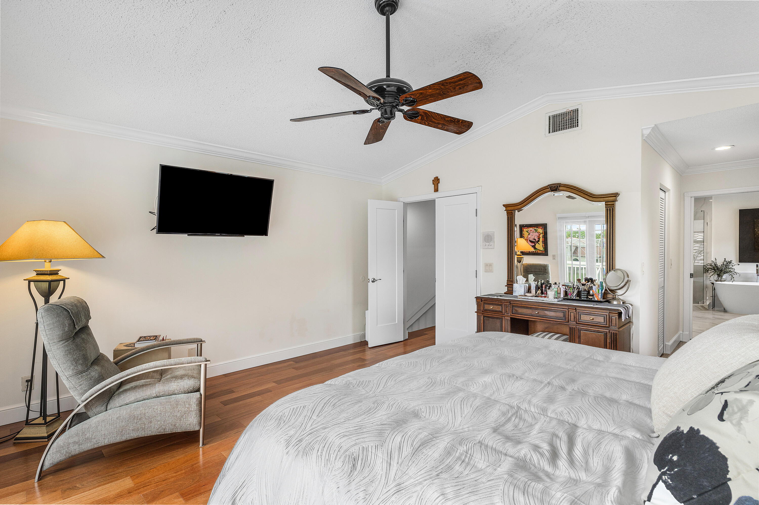 10824 Tea Olive Lane Boca Raton, FL 33498 - Photo 28 of 76 a bedroom with a bed and a flat screen tv