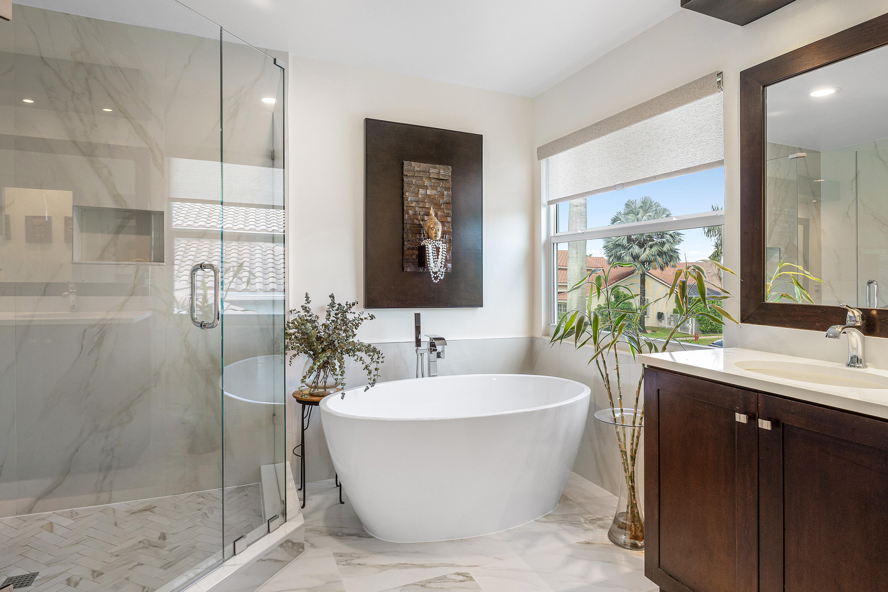 10824 Tea Olive Lane Boca Raton, FL 33498 - Photo 30 of 76 a bathroom with a white tub a sink and glass door