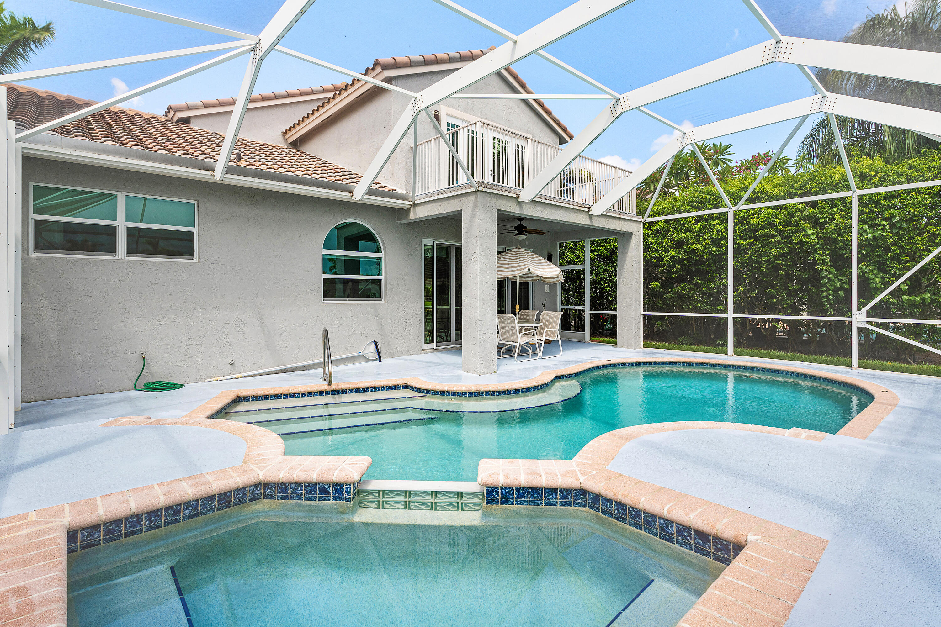 10824 Tea Olive Lane Boca Raton, FL 33498 - Photo 44 of 76 a front view of house with swimming pool and outdoor seating