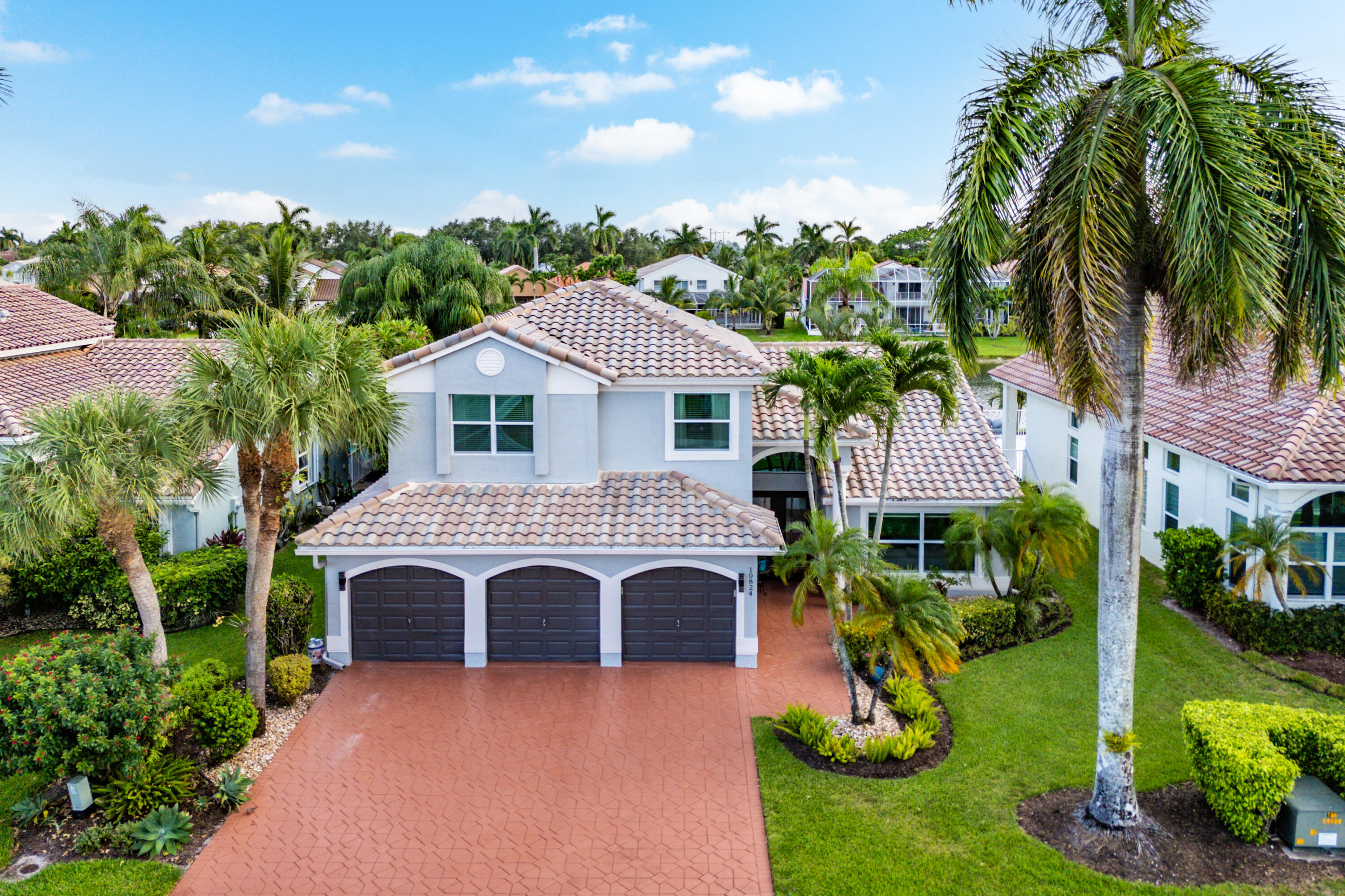 10824 Tea Olive Lane Boca Raton, FL 33498 - Photo 49 of 76 a front view of a house with garden