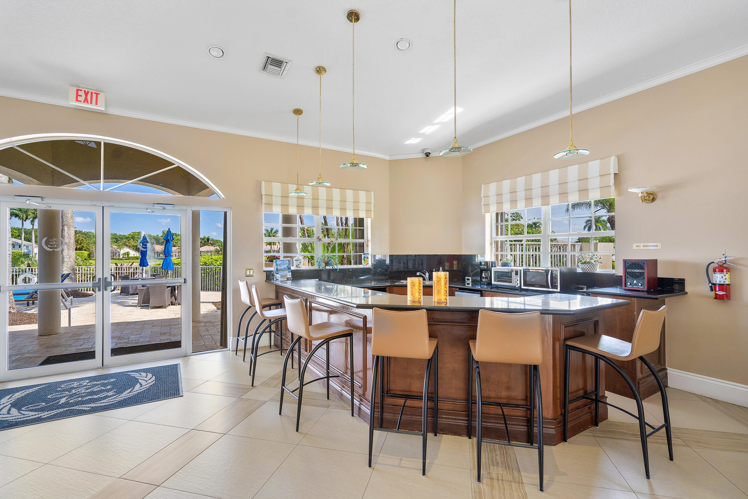 10824 Tea Olive Lane Boca Raton, FL 33498 - Photo 56 of 76 a dining hall with stainless steel appliances kitchen island granite countertop a table chairs and a living room view