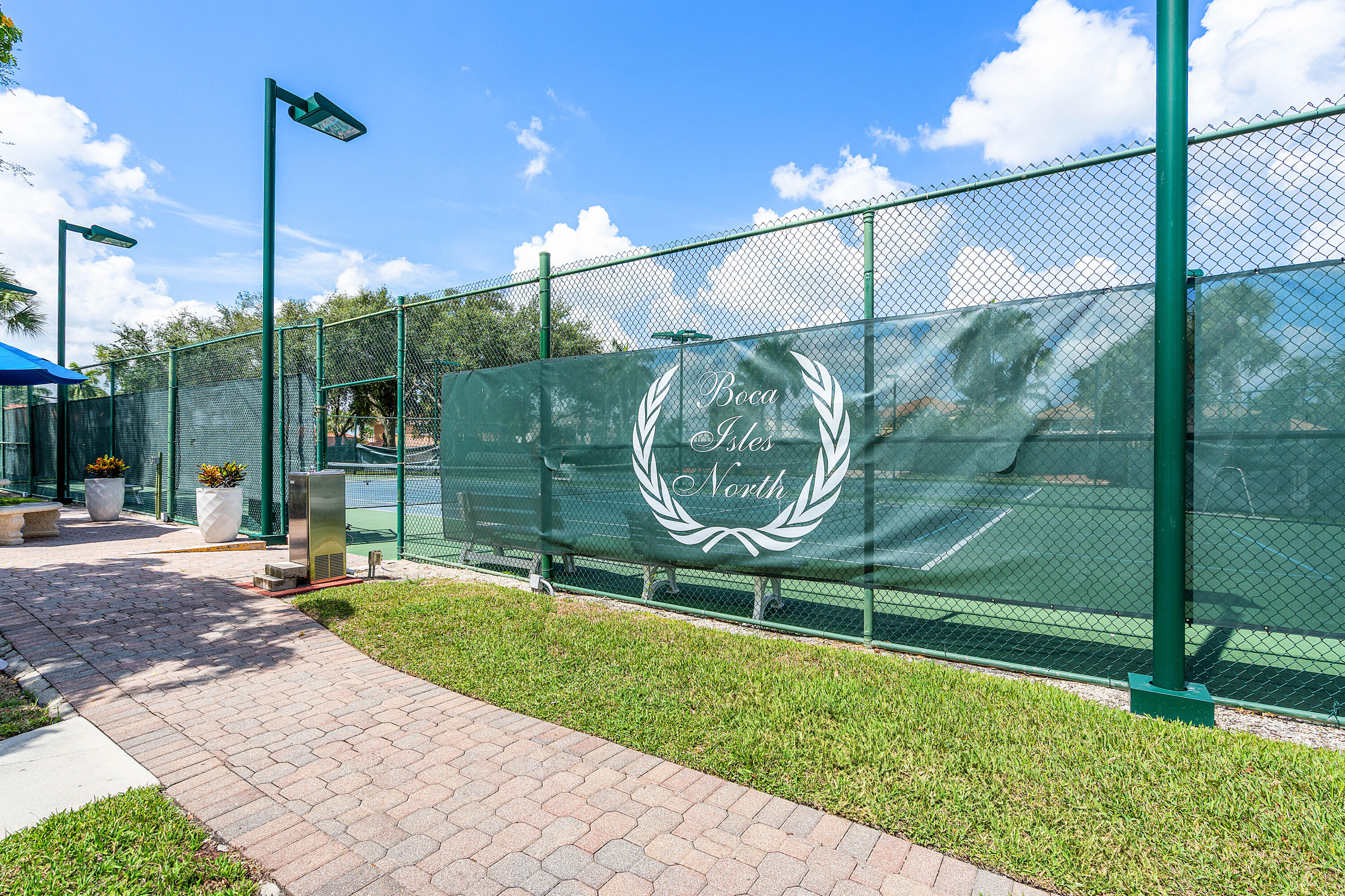 10824 Tea Olive Lane Boca Raton, FL 33498 - Photo 66 of 76 a view of a chair and tables in the patio
