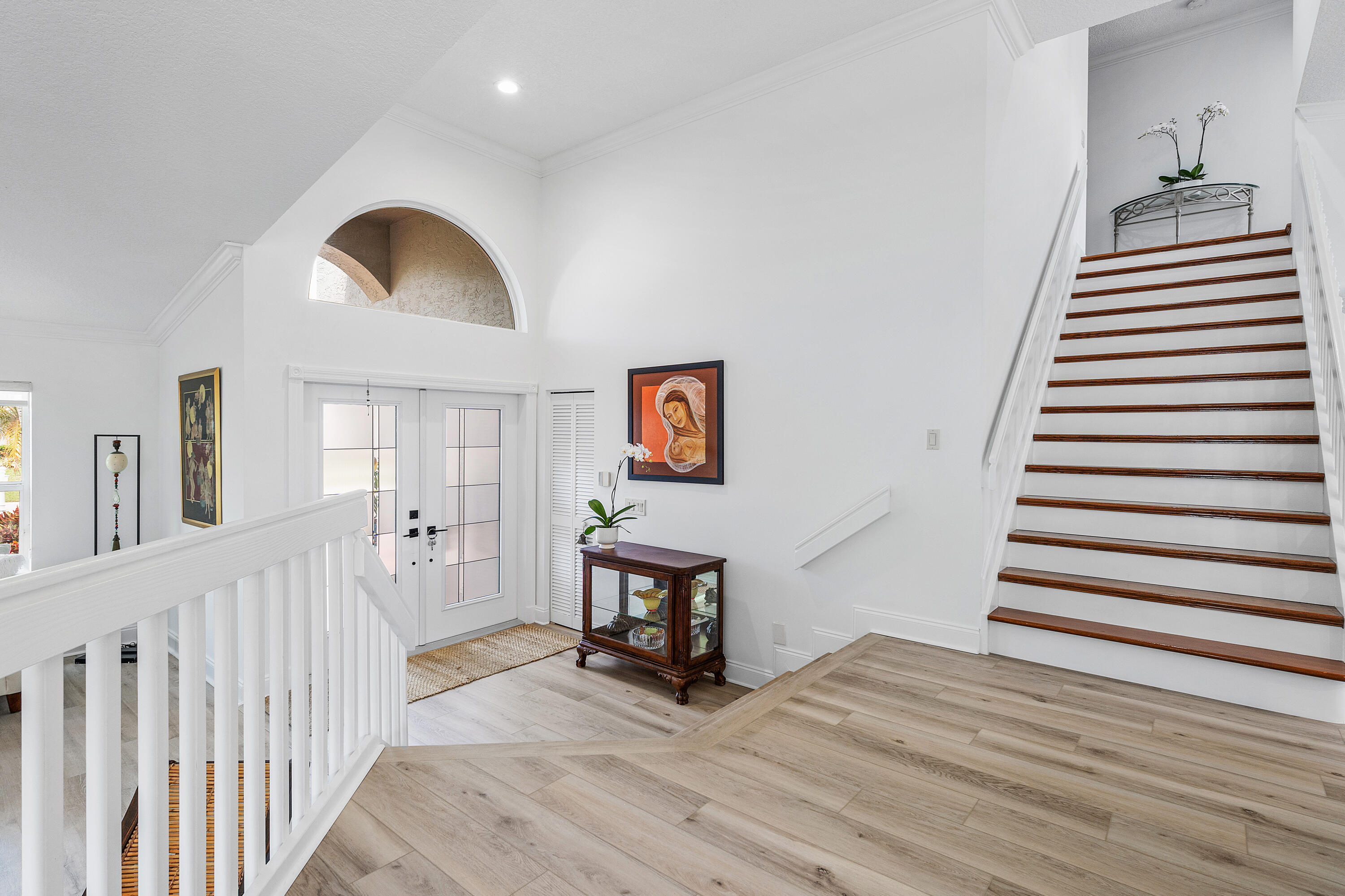 10824 Tea Olive Lane Boca Raton, FL 33498 - Photo 9 of 76 a view of a hallway with wooden floor and staircase
