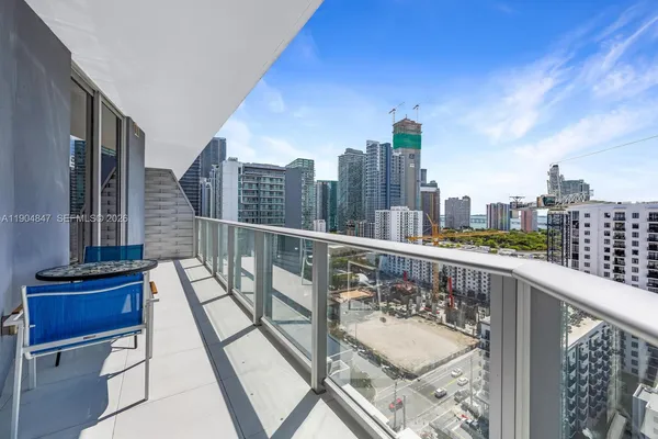 a view of a balcony with two chairs and a table