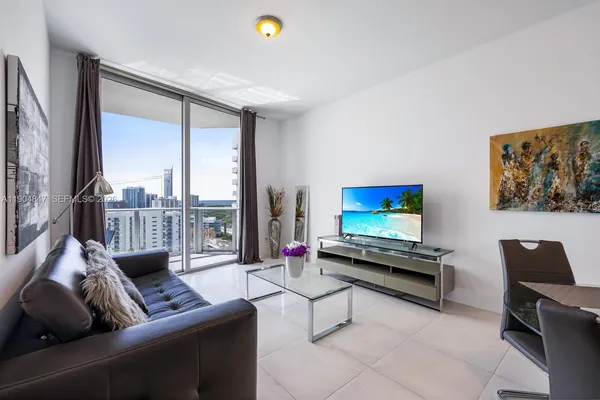 a living room with furniture and a flat screen tv