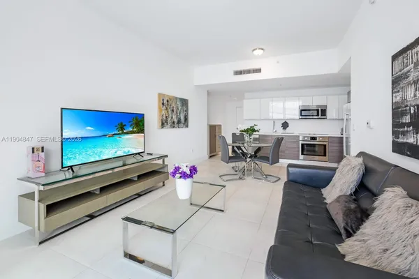 a living room with furniture and a flat screen tv