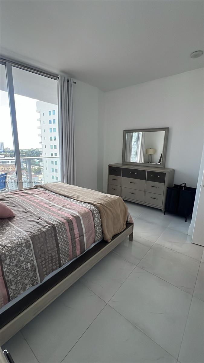 Brickell Miami, FL 33130 - Photo 7 of 12 a bedroom with a bed and window