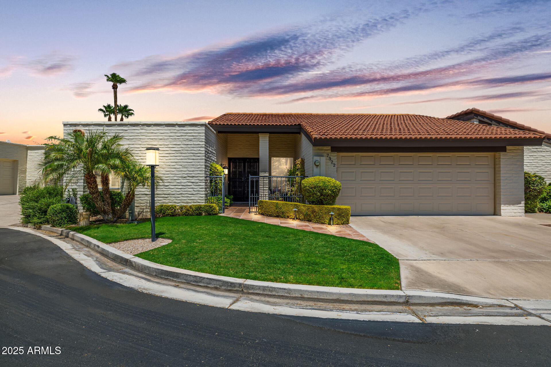 7322 East McLellan Boulevard Scottsdale, AZ 85250 - Photo 1 of 64 a front view of a house with a yard and garage