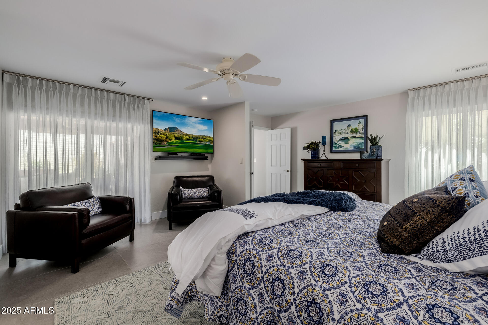 7322 East McLellan Boulevard Scottsdale, AZ 85250 - Photo 29 of 64 a bedroom with a bed couches and a flat tv screen