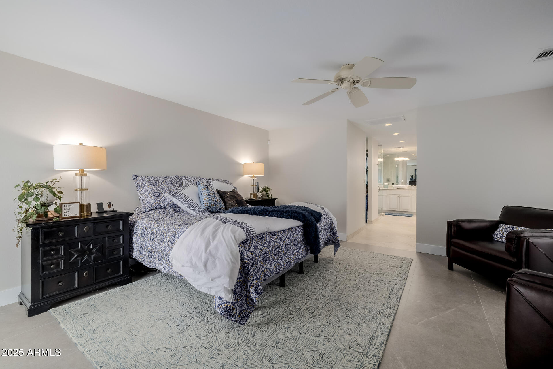 7322 East McLellan Boulevard Scottsdale, AZ 85250 - Photo 30 of 64 a spacious bedroom with a bed a couch and a chandelier