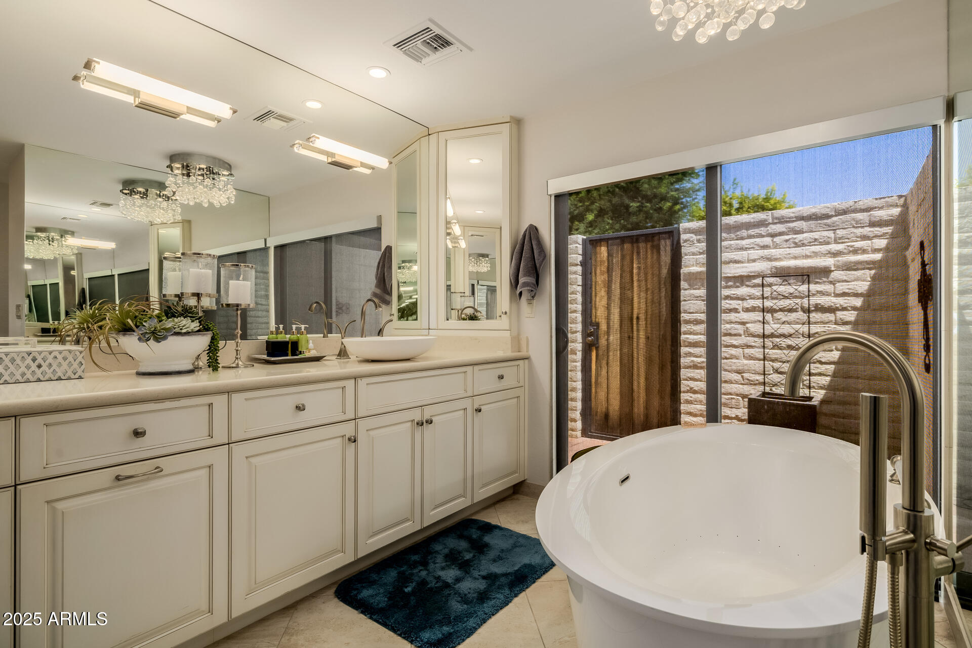 7322 East McLellan Boulevard Scottsdale, AZ 85250 - Photo 33 of 64 a bathroom with a double vanity sink a mirror a bathtub and shower