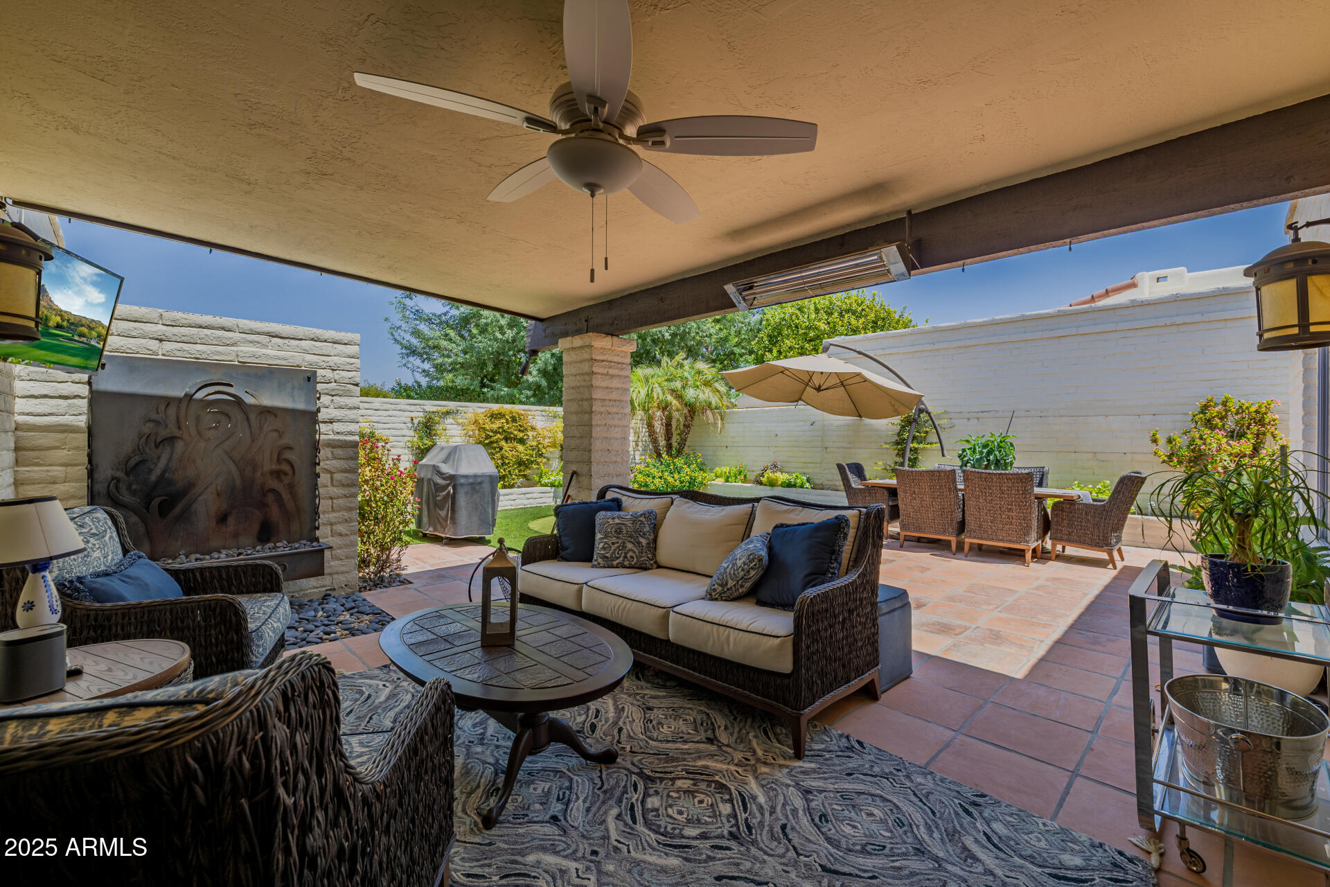 7322 East McLellan Boulevard Scottsdale, AZ 85250 - Photo 47 of 64 a living room with furniture a ceiling fan and a flat screen tv