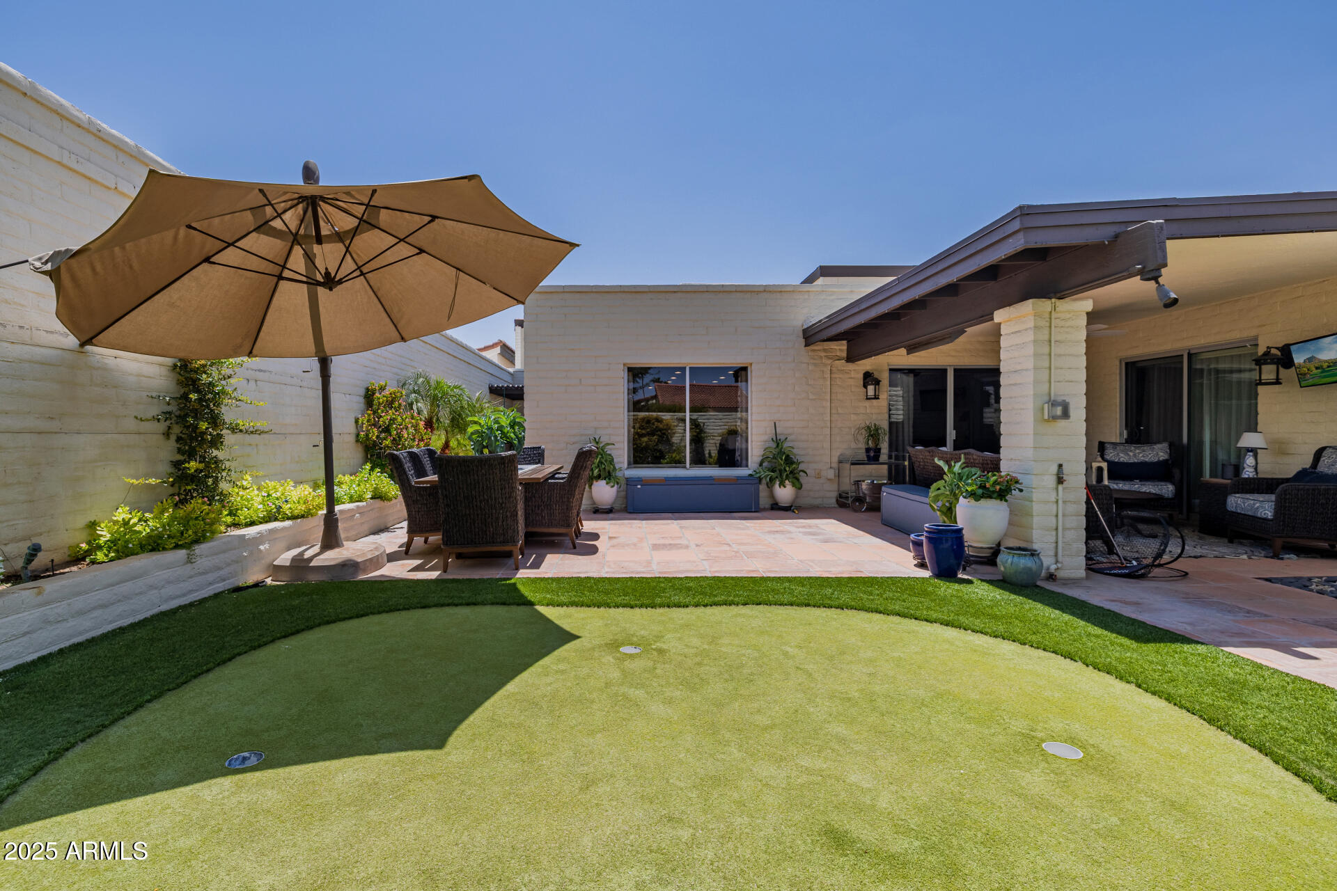 7322 East McLellan Boulevard Scottsdale, AZ 85250 - Photo 48 of 64 a view of a house with backyard porch and sitting area