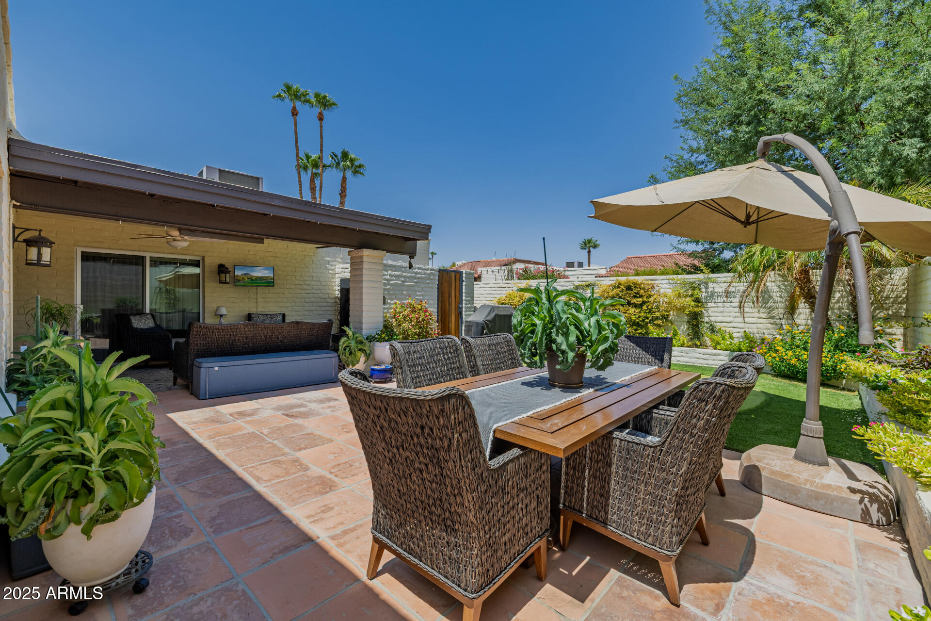 7322 East McLellan Boulevard Scottsdale, AZ 85250 - Photo 49 of 64 a view of a patio with a table and chairs under an umbrella