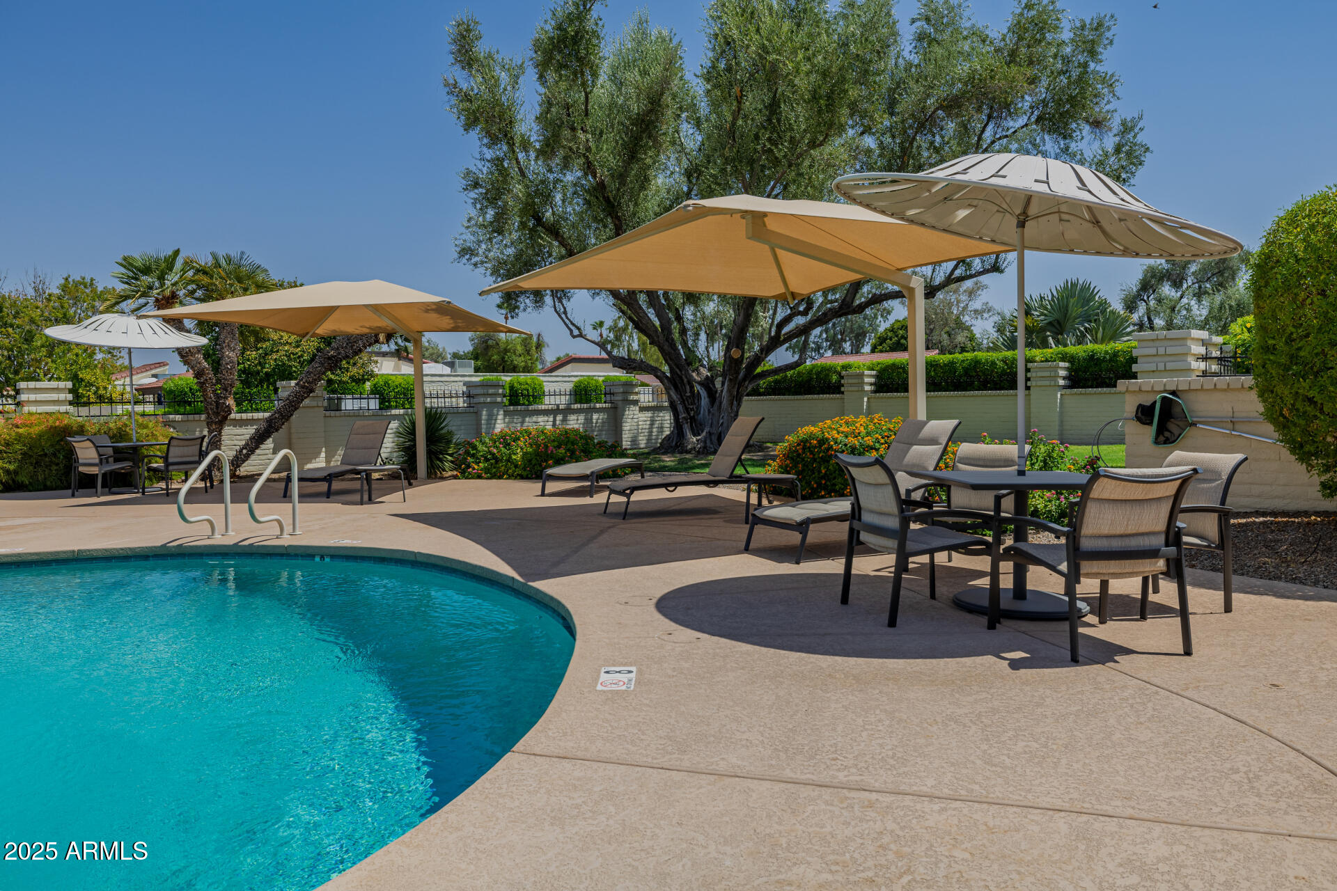 7322 East McLellan Boulevard Scottsdale, AZ 85250 - Photo 60 of 64 a patio with a table and chairs under an umbrella