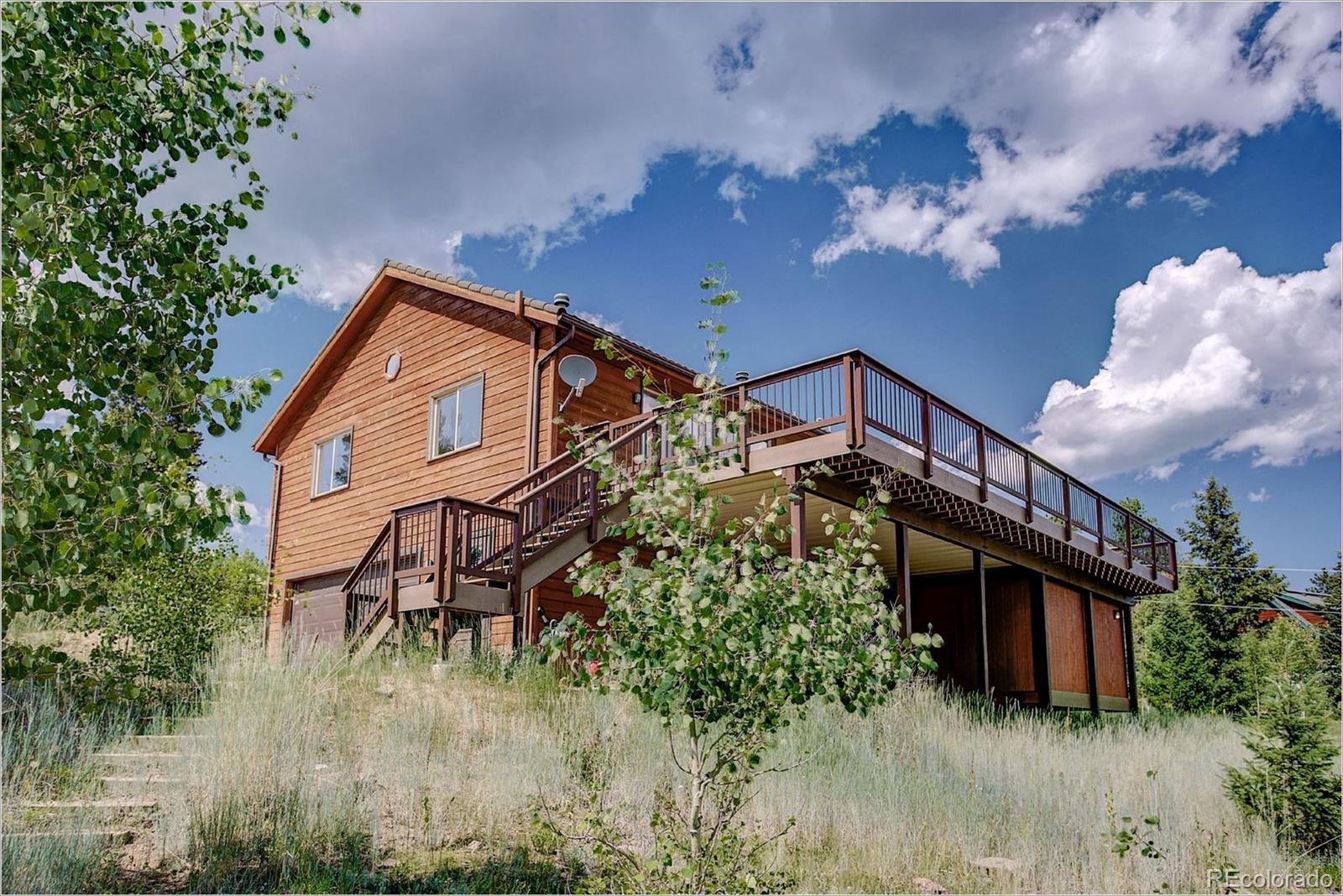 763 Desperado Road Bailey, CO 80421 - Photo 2 of 32 a backyard of a house with lots of green space