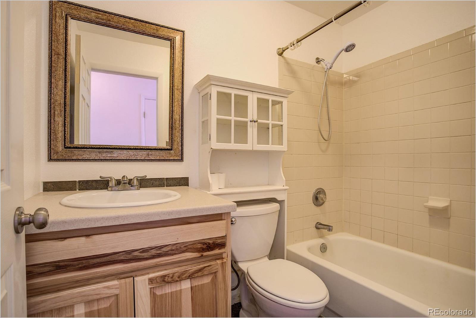 763 Desperado Road Bailey, CO 80421 - Photo 9 of 32 a bathroom with a sink toilet and shower