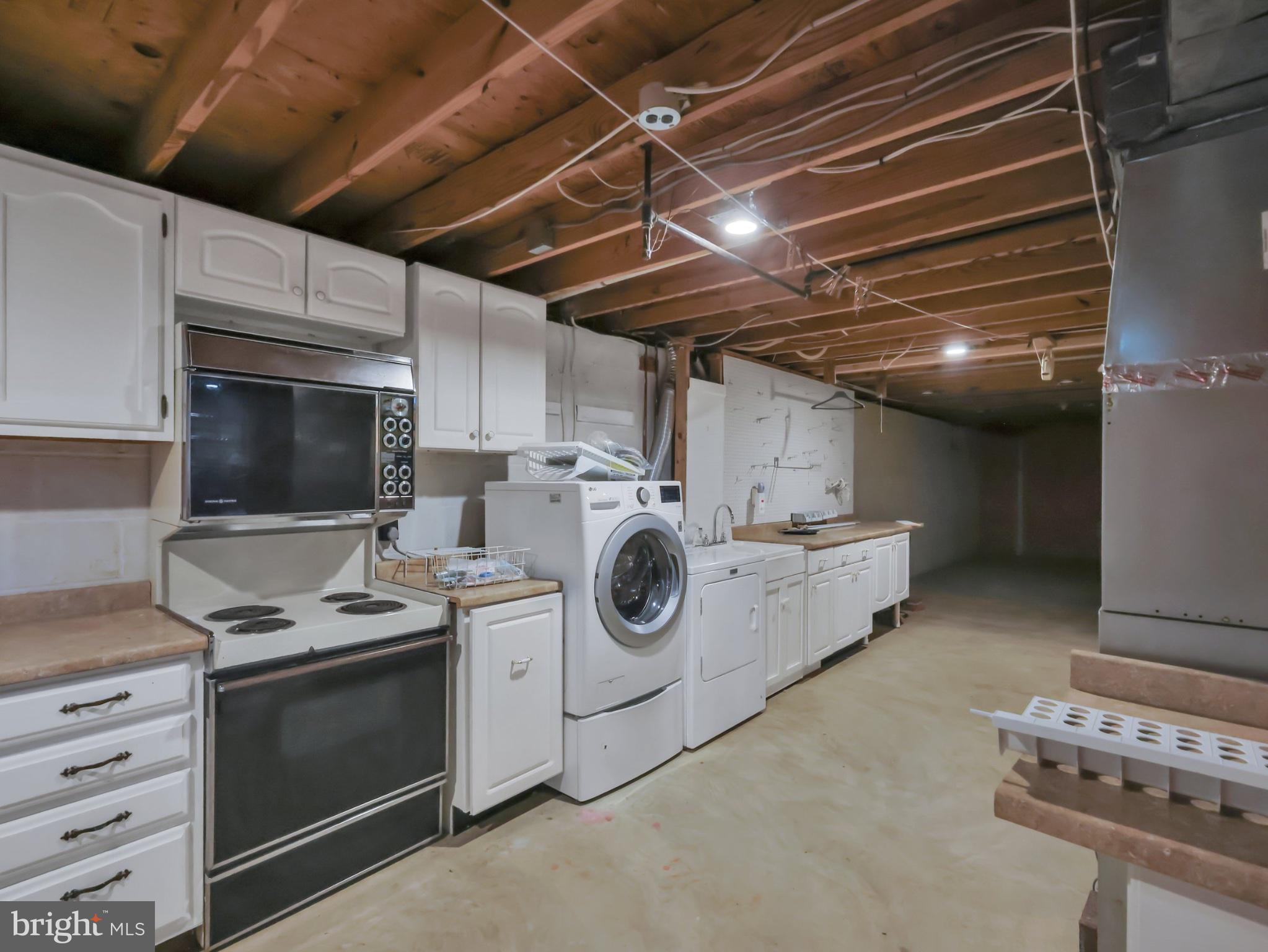 18 Windmill Court Silver Spring, MD 20905 - Photo 32 of 37 Spacious basement laundry area awaits.